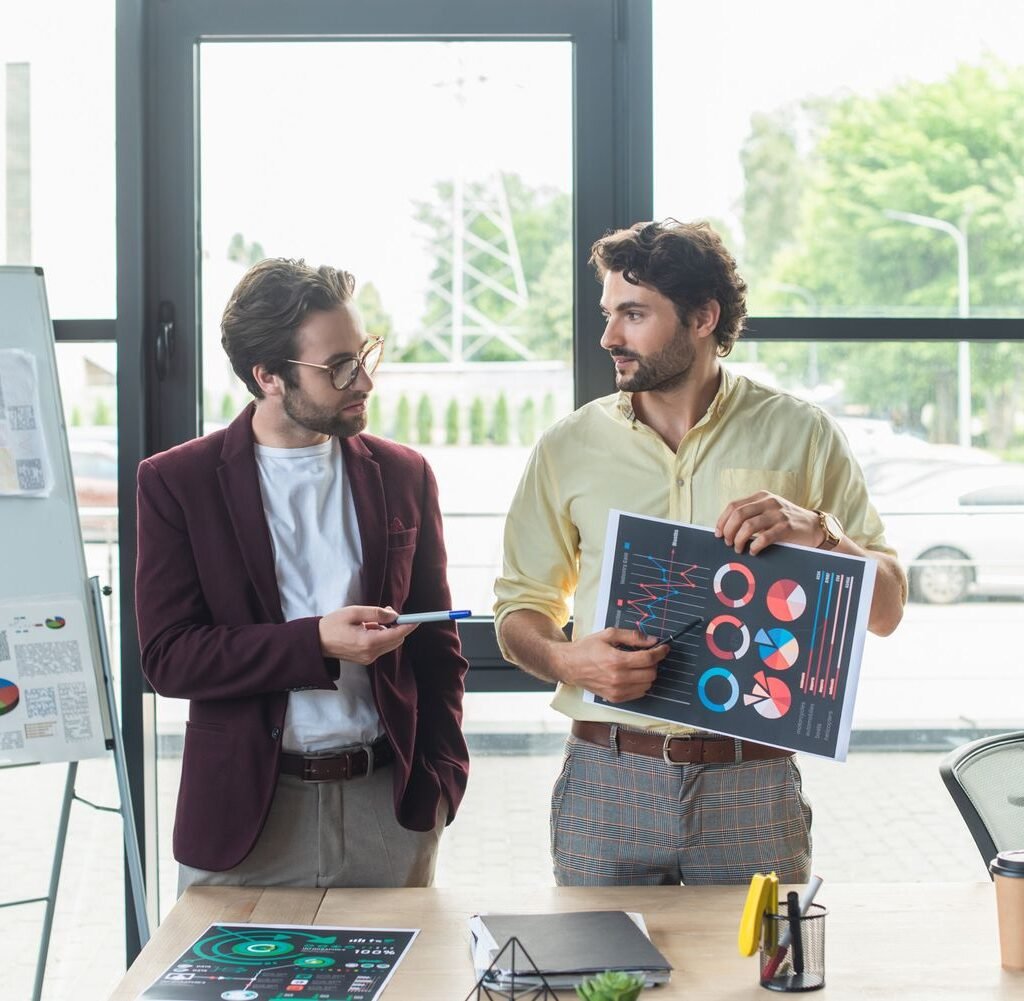 businessmen pointing at document with charts while fysv8ey